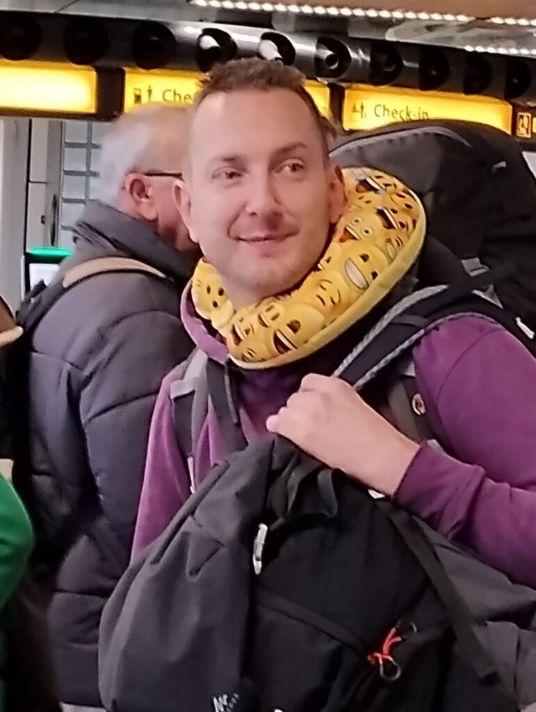 On Schiphol with my backpacks and smile pillow